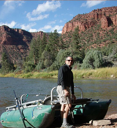 Man with Boat at River's Edge